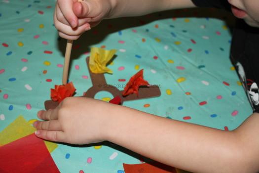 Placing tissue paper on the fire